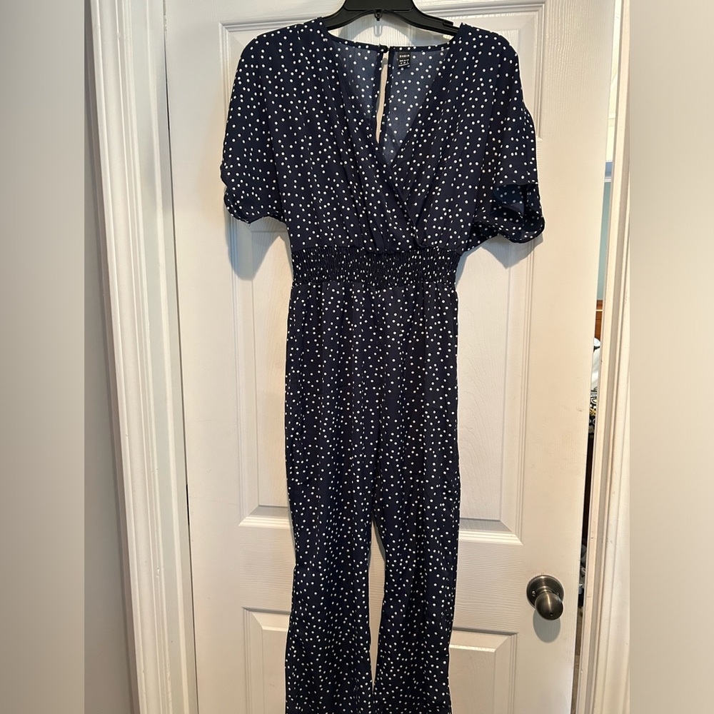 Navy blue polka dot 1 piece romper.